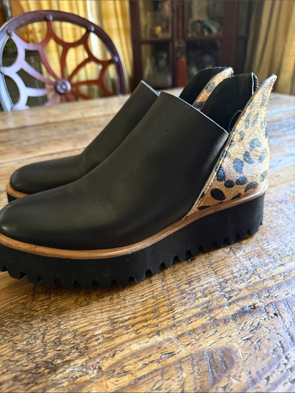All black brand Women's Black Leather Wedge Slip-On Shoes with Leopard Accent